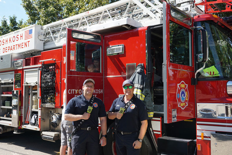 The City of Oshkosh Fire Department poses for a picture at our Touch a Truck event down at the Leach Amphitheater on a beautiful fall day
