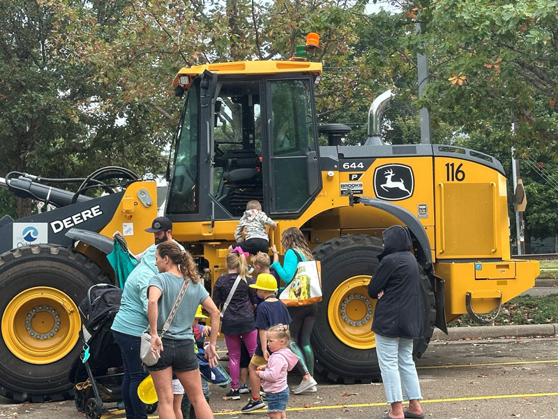 Children checking out the Oshkosh Public works front end loader at the Touch a Truck event down at the Leach Amphitheater